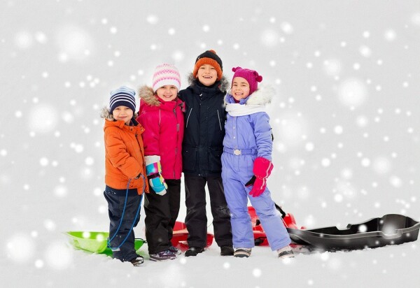 Young happy children standing in the snow.