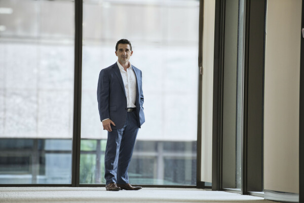 A stylish image of Peter Magnisalis in a well lit office