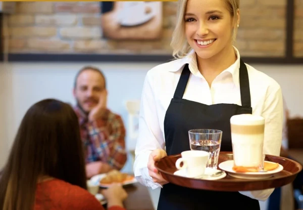 Young woman serving hot chocolate and coffee in a cafe